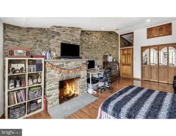 a living room with furniture flat screen tv and a fireplace