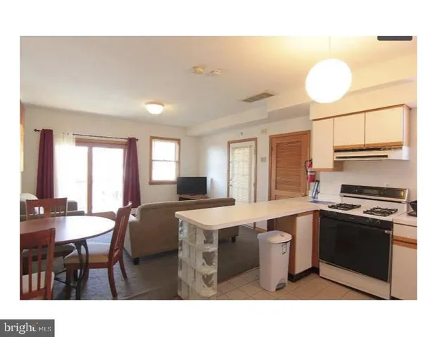 a kitchen with a sink cabinets and window