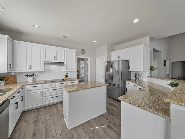 a kitchen with lot of counter space sink and appliances