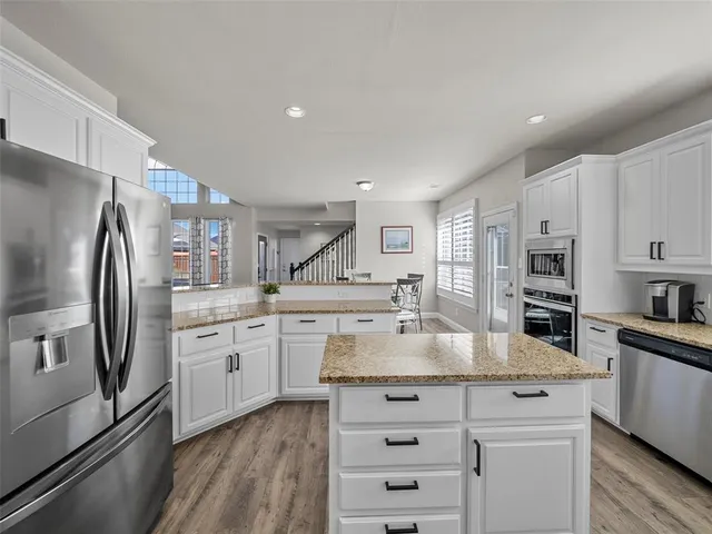 a kitchen with a refrigerator and a sink