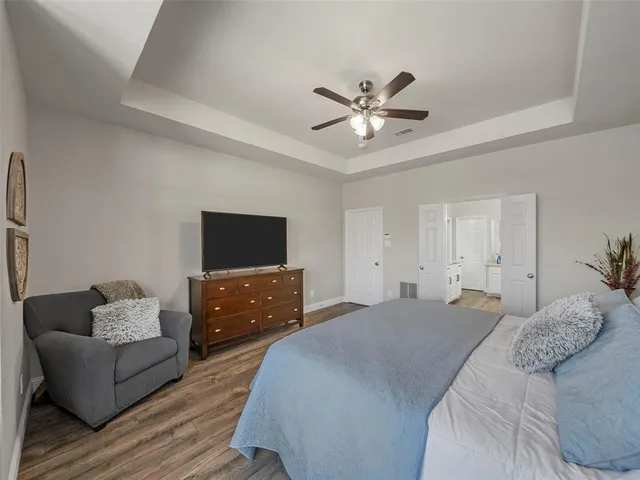 a bathroom with a bathtub a double vanity sink and mirror