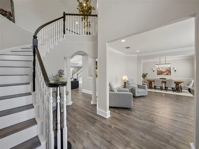 a view of an empty room with glass door and furniture