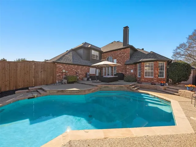 a view of a house with swimming pool yard and patio