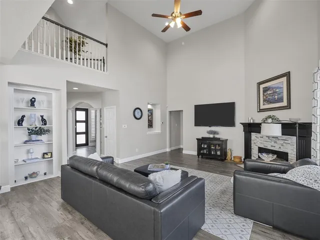 a living room with furniture fireplace and flat screen tv