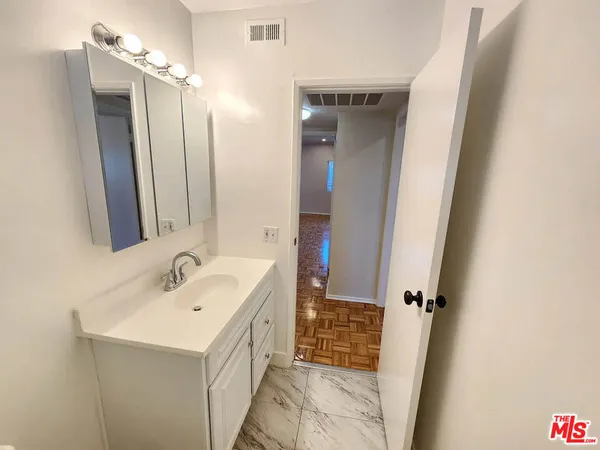 a bathroom with a sink a mirror and a shower