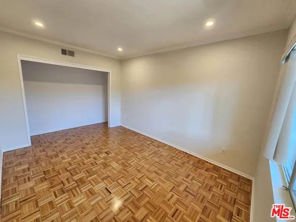 an empty room with wooden floor