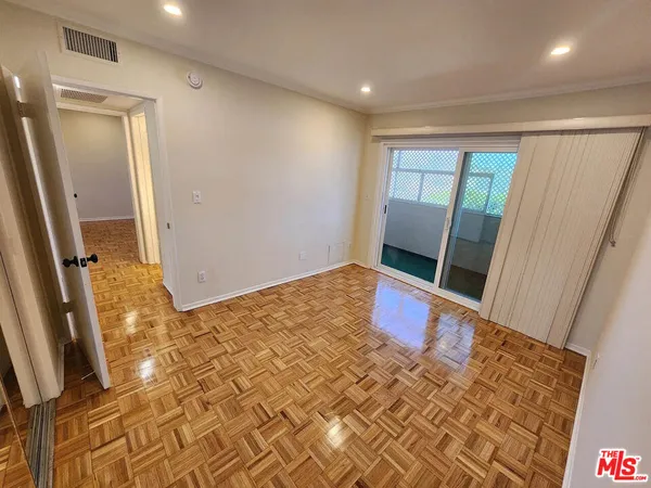 a bedroom with a bed and a mirror