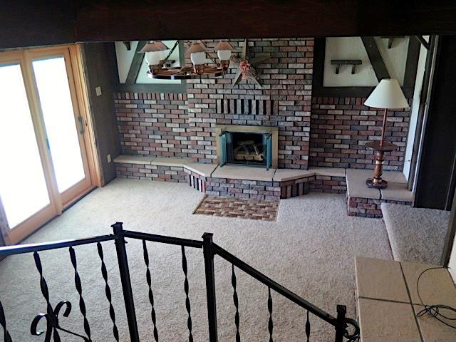 2453 Ridge Road McKeesport, PA 15135 - Photo 13 of 19 This is the view you have of the family room when coming down the stairs. Gas log fireplace and brand new neutral carpet. Pella door to outside patio.