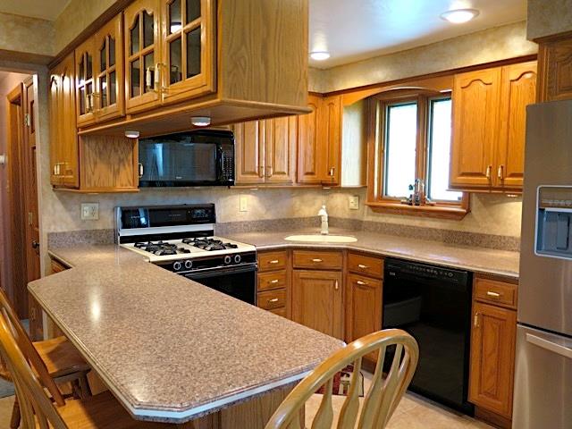 2453 Ridge Road McKeesport, PA 15135 - Photo 3 of 19 Updated kitchen that makes good use of overhead storage and counter space. The breakfast bar for added convenience. All appliances stay along with the wood stools.