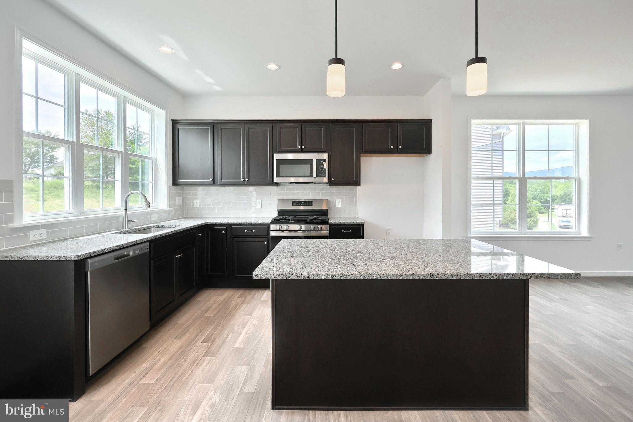 63 Glenn View Carlisle, PA 17013 - Photo 2 of 20 a kitchen with stainless steel appliances granite countertop a sink a stove a refrigerator cabinets and a large window