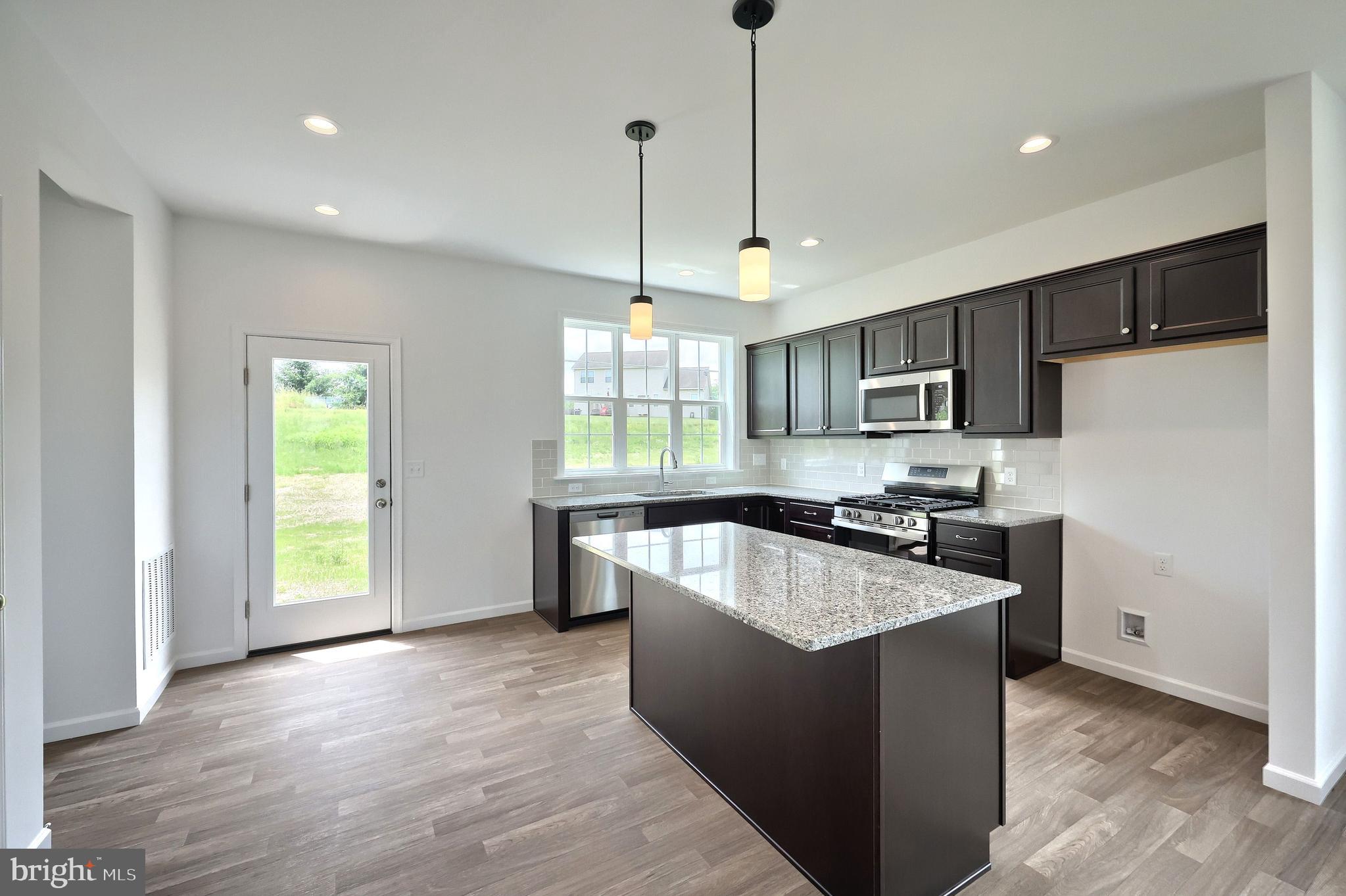 63 Glenn View Carlisle, PA 17013 - Photo 5 of 20 a large kitchen with stainless steel appliances granite countertop a refrigerator a sink dishwasher a oven and a kitchen island