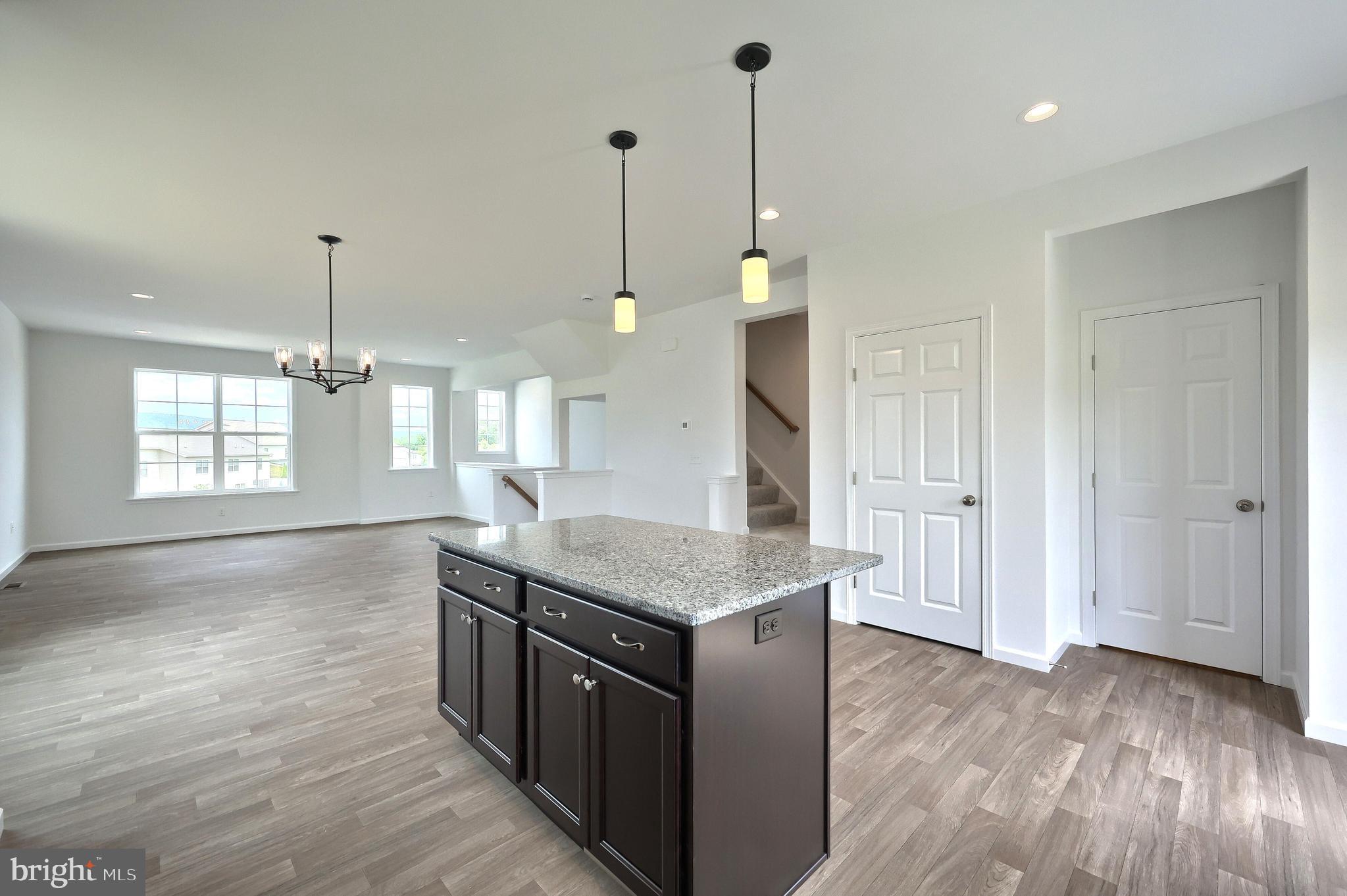63 Glenn View Carlisle, PA 17013 - Photo 7 of 20 a kitchen with stainless steel appliances granite countertop a stove a sink a center island and a wooden floor