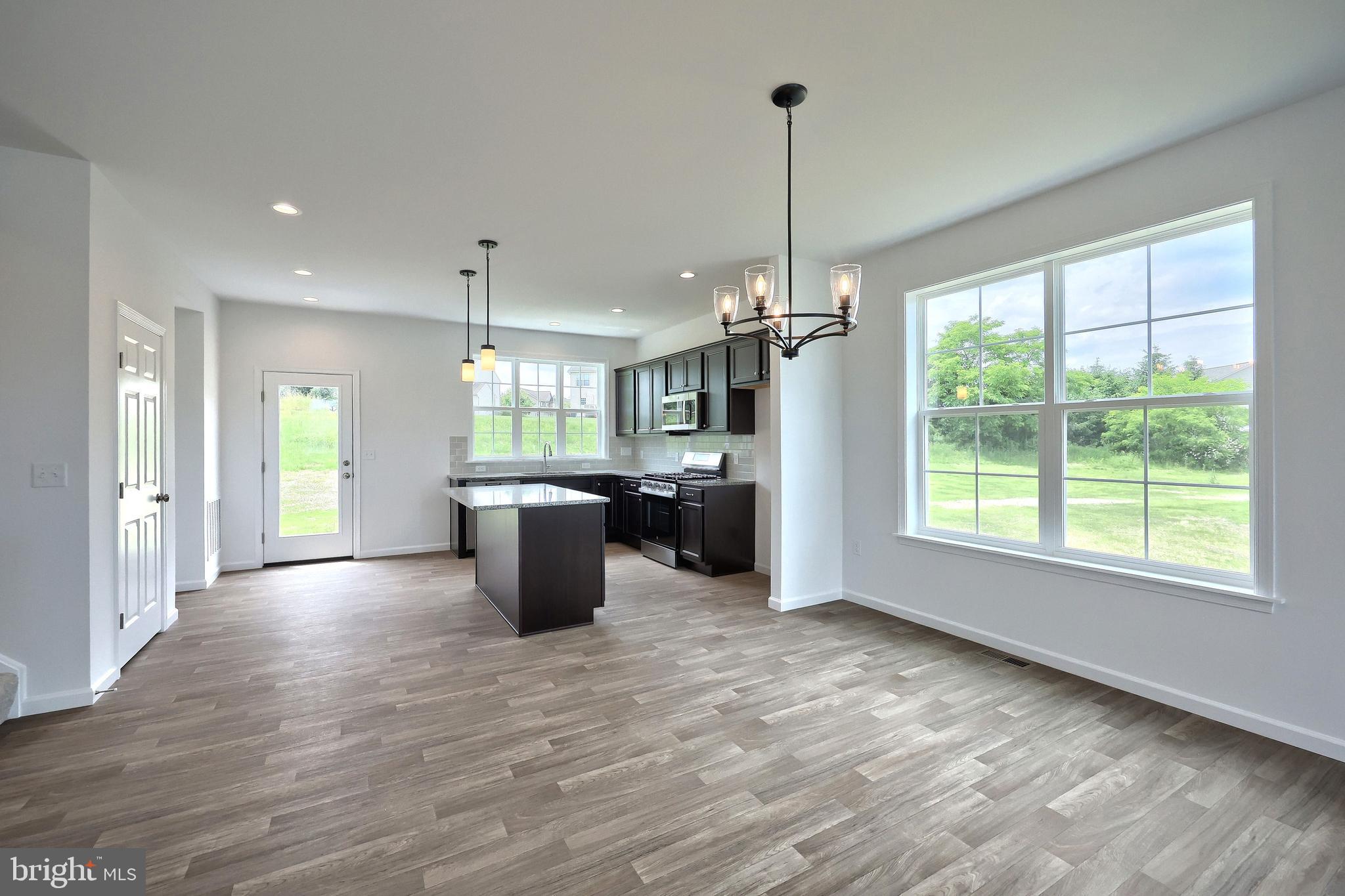 63 Glenn View Carlisle, PA 17013 - Photo 8 of 20 a open kitchen with kitchen island a stove a counter space and wooden floor