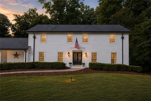 a front view of a house with garden