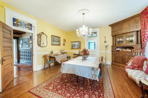 a dining room with furniture window and wooden floor