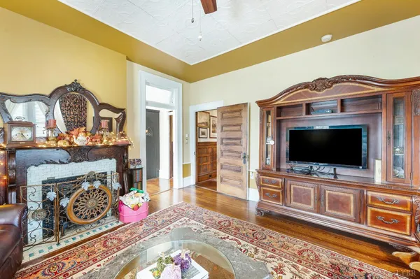 a kitchen with stainless steel appliances granite countertop a refrigerator a sink dishwasher a stove and white countertops with wooden floor