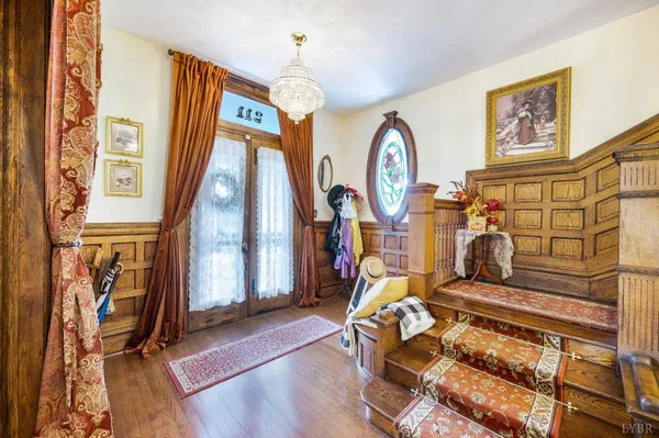 a view of entryway and hall with wooden floor