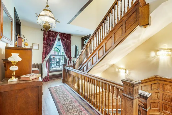 a dining room with furniture window and wooden floor