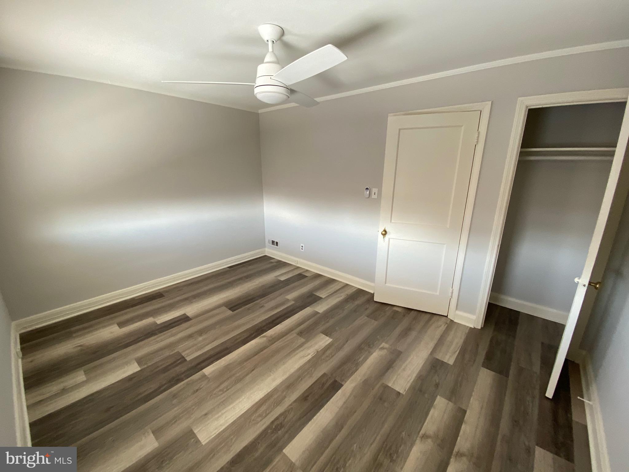 338 Gusryan Street Baltimore, MD 21224 - Photo 11 of 20 wooden floor in an empty room