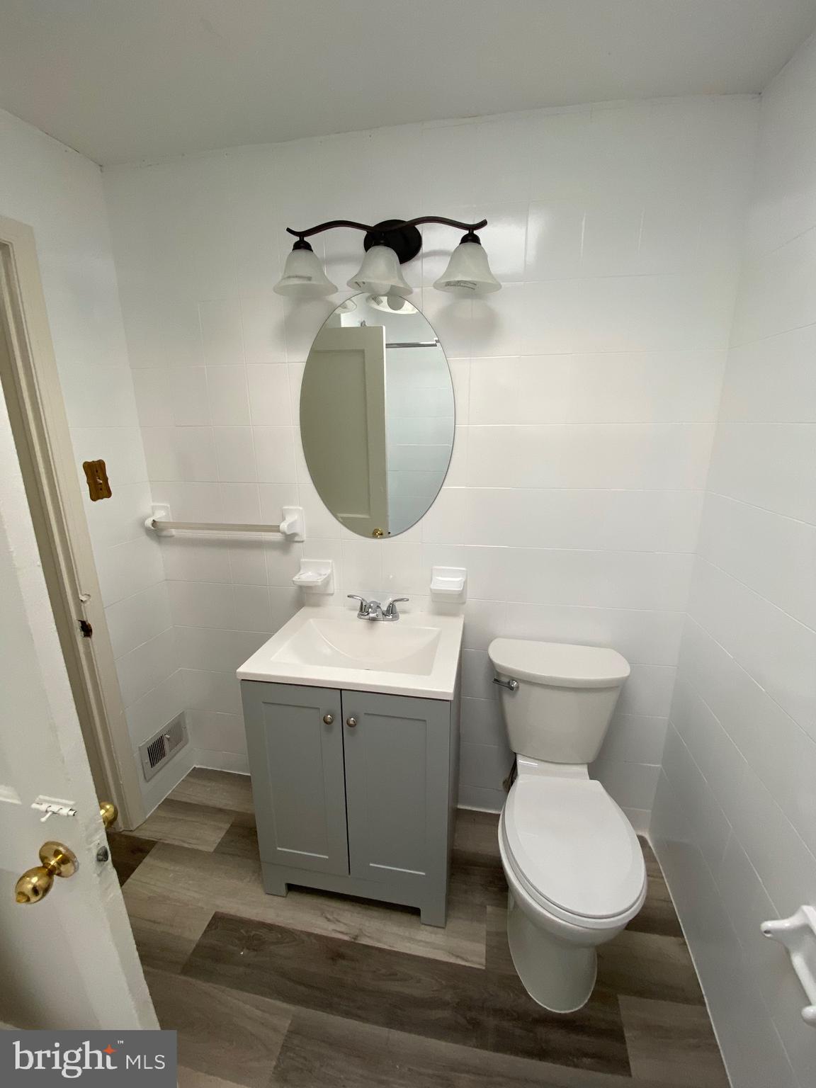 338 Gusryan Street Baltimore, MD 21224 - Photo 13 of 20 a bathroom with a toilet sink and mirror