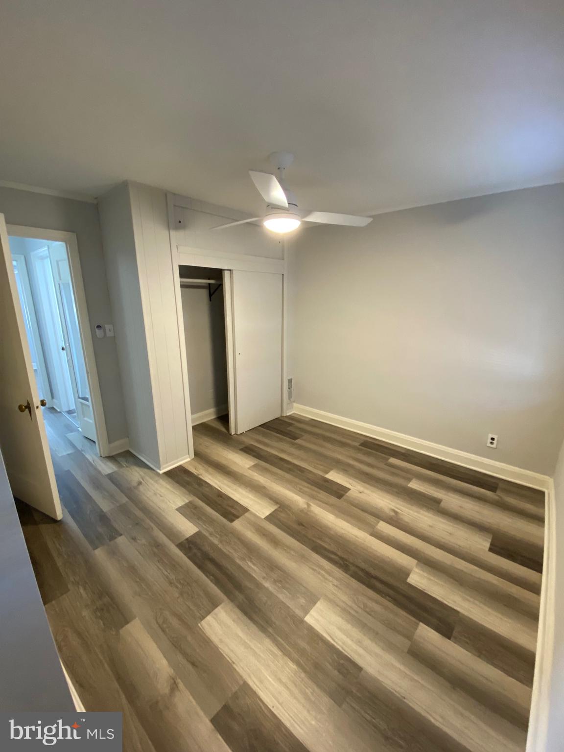 338 Gusryan Street Baltimore, MD 21224 - Photo 15 of 20 a view of a room with wooden floor and window