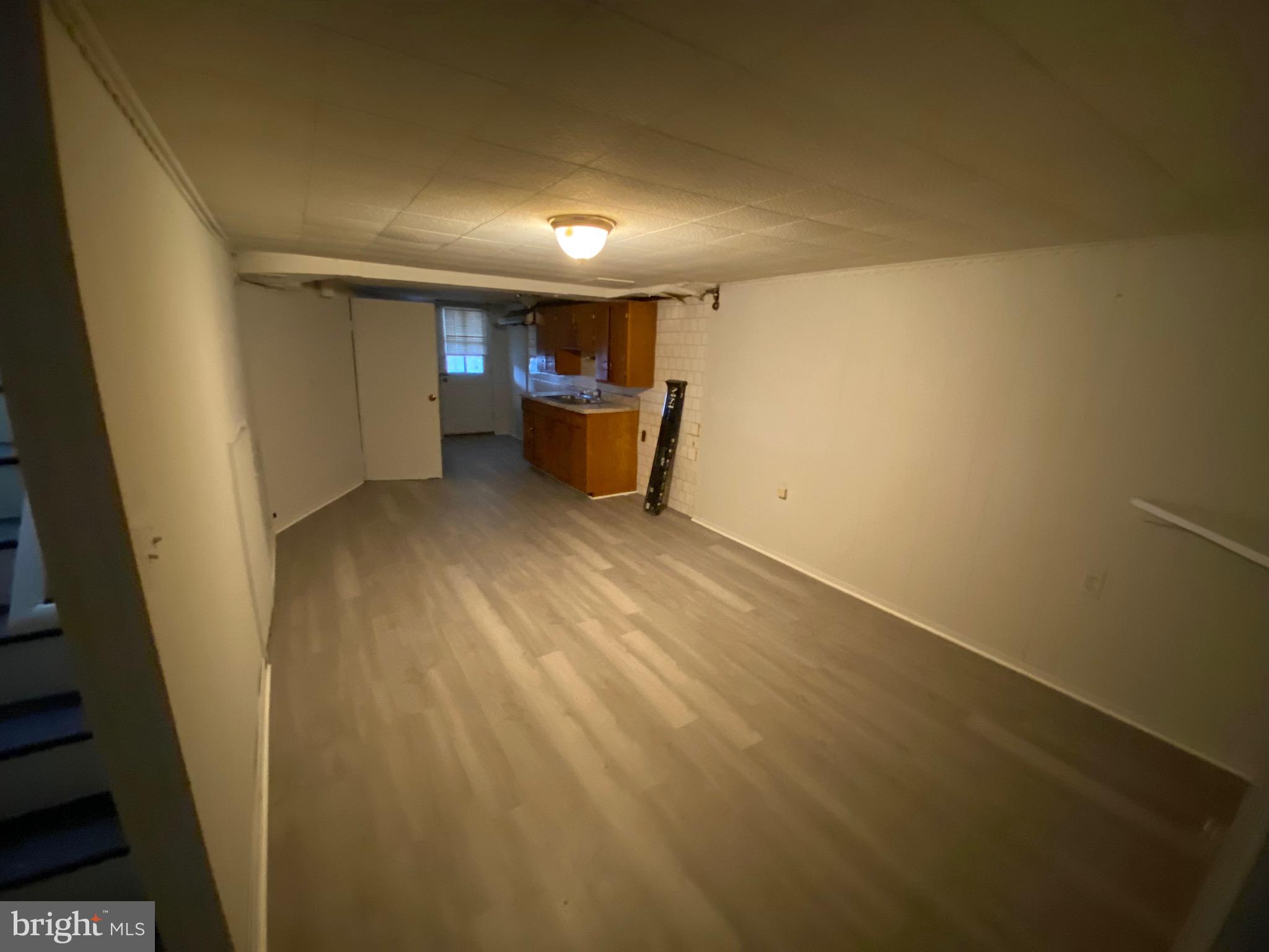 338 Gusryan Street Baltimore, MD 21224 - Photo 17 of 20 a view of a room with wooden floor
