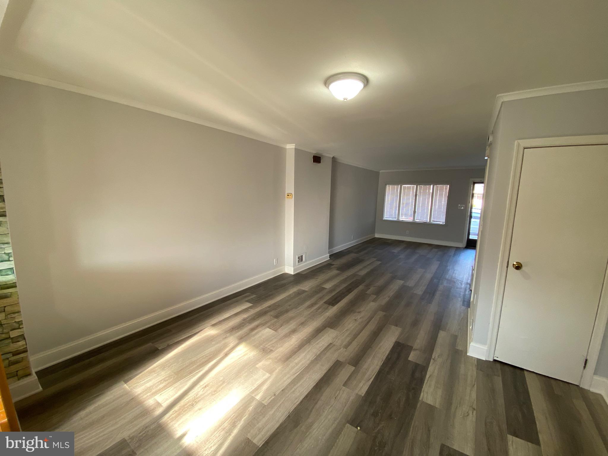 338 Gusryan Street Baltimore, MD 21224 - Photo 5 of 20 a view of an empty room and wooden floor