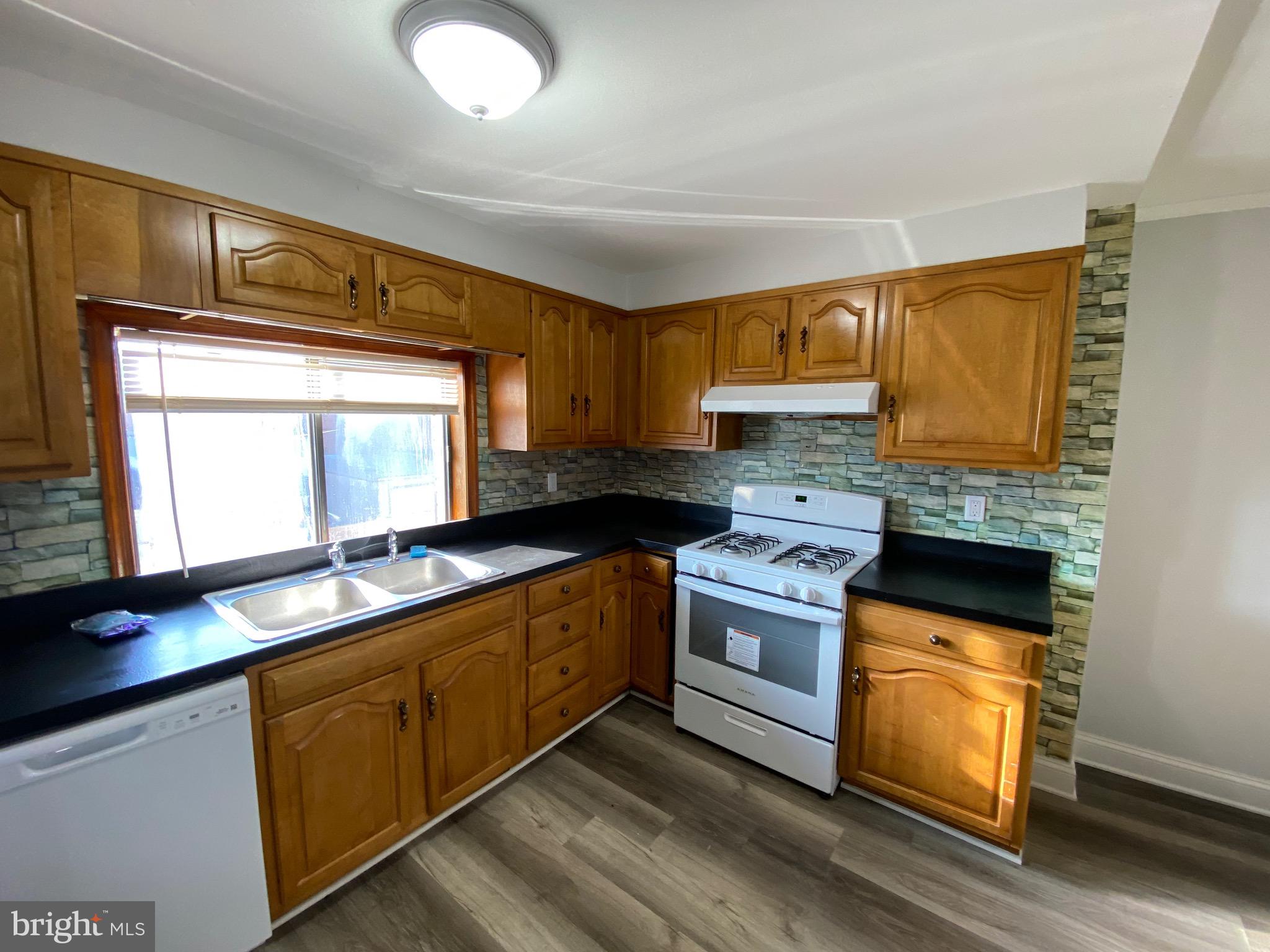 338 Gusryan Street Baltimore, MD 21224 - Photo 9 of 20 a kitchen with a sink stove and cabinets