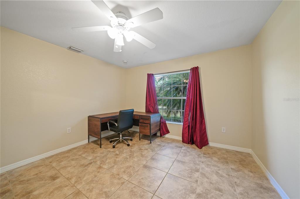 1291 Impala Street North Port, FL 34288 - Photo 11 of 44 a view of a workspace with furniture and a window