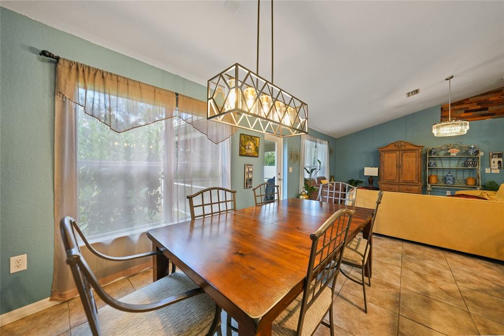 1291 Impala Street North Port, FL 34288 - Photo 13 of 44 a dining room with furniture and window