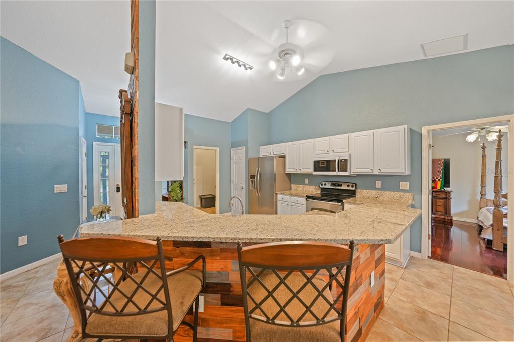 1291 Impala Street North Port, FL 34288 - Photo 14 of 44 a large kitchen with a table and chairs