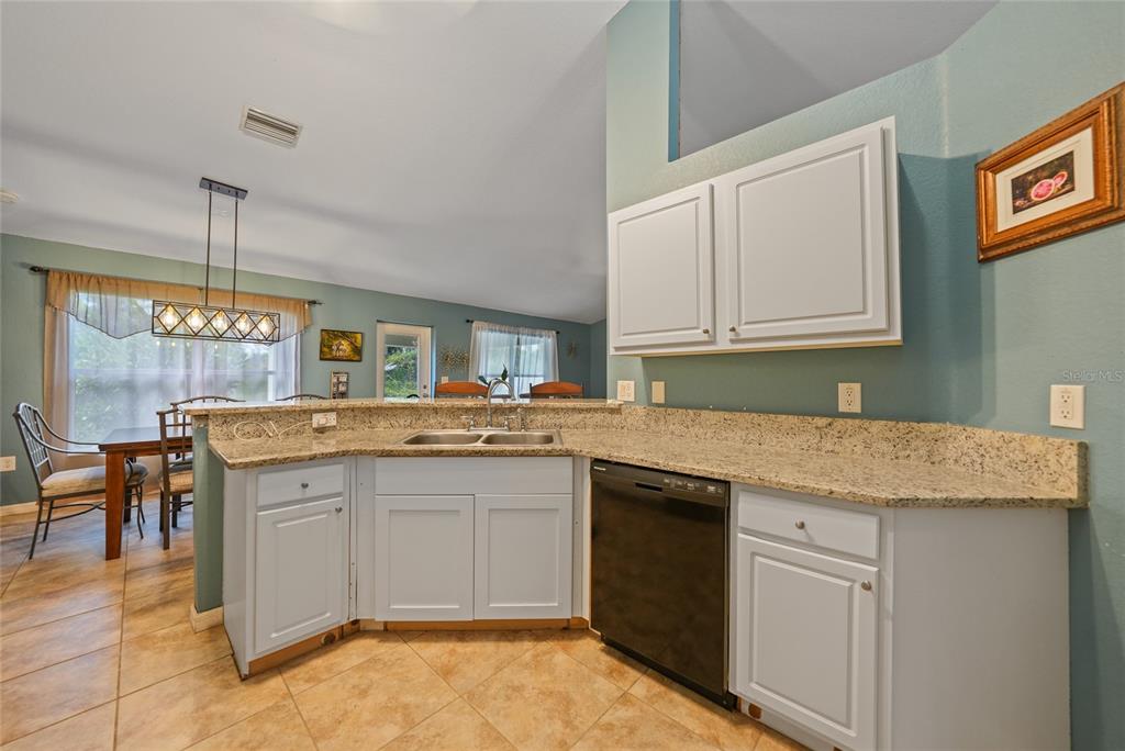 1291 Impala Street North Port, FL 34288 - Photo 17 of 44 a kitchen with a sink and cabinets