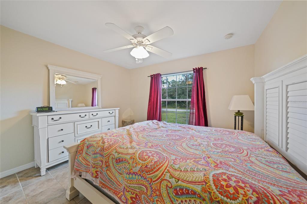 1291 Impala Street North Port, FL 34288 - Photo 25 of 44 a bedroom with a bed and a dresser