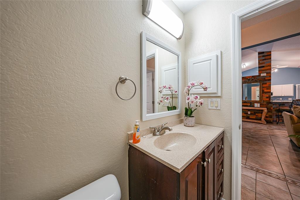 1291 Impala Street North Port, FL 34288 - Photo 27 of 44 a bathroom with a sink vanity mirror and toilet