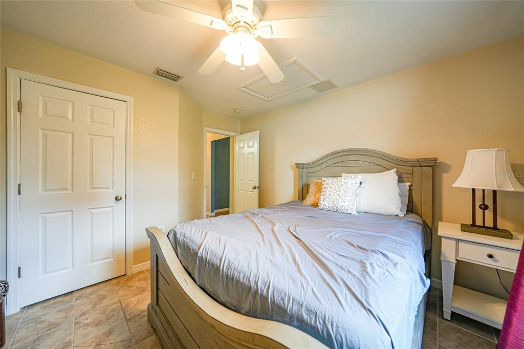1291 Impala Street North Port, FL 34288 - Photo 29 of 44 a bedroom with a bed and a chandelier