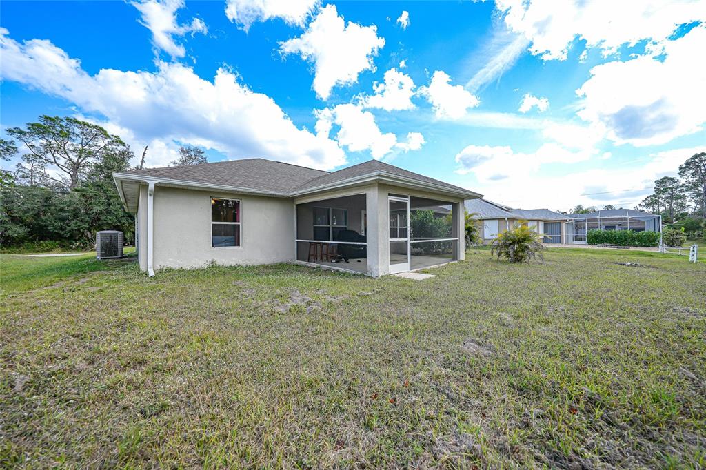 1291 Impala Street North Port, FL 34288 - Photo 36 of 44 a view of a house with yard and a garden