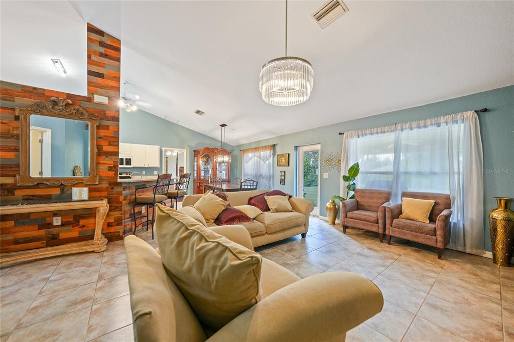 1291 Impala Street North Port, FL 34288 - Photo 6 of 44 a living room with furniture a rug and a large window