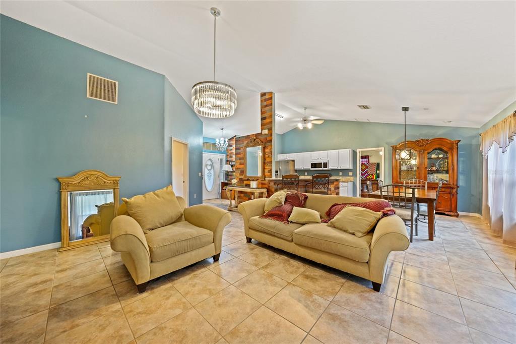 1291 Impala Street North Port, FL 34288 - Photo 8 of 44 a living room with furniture ceiling fan and a rug