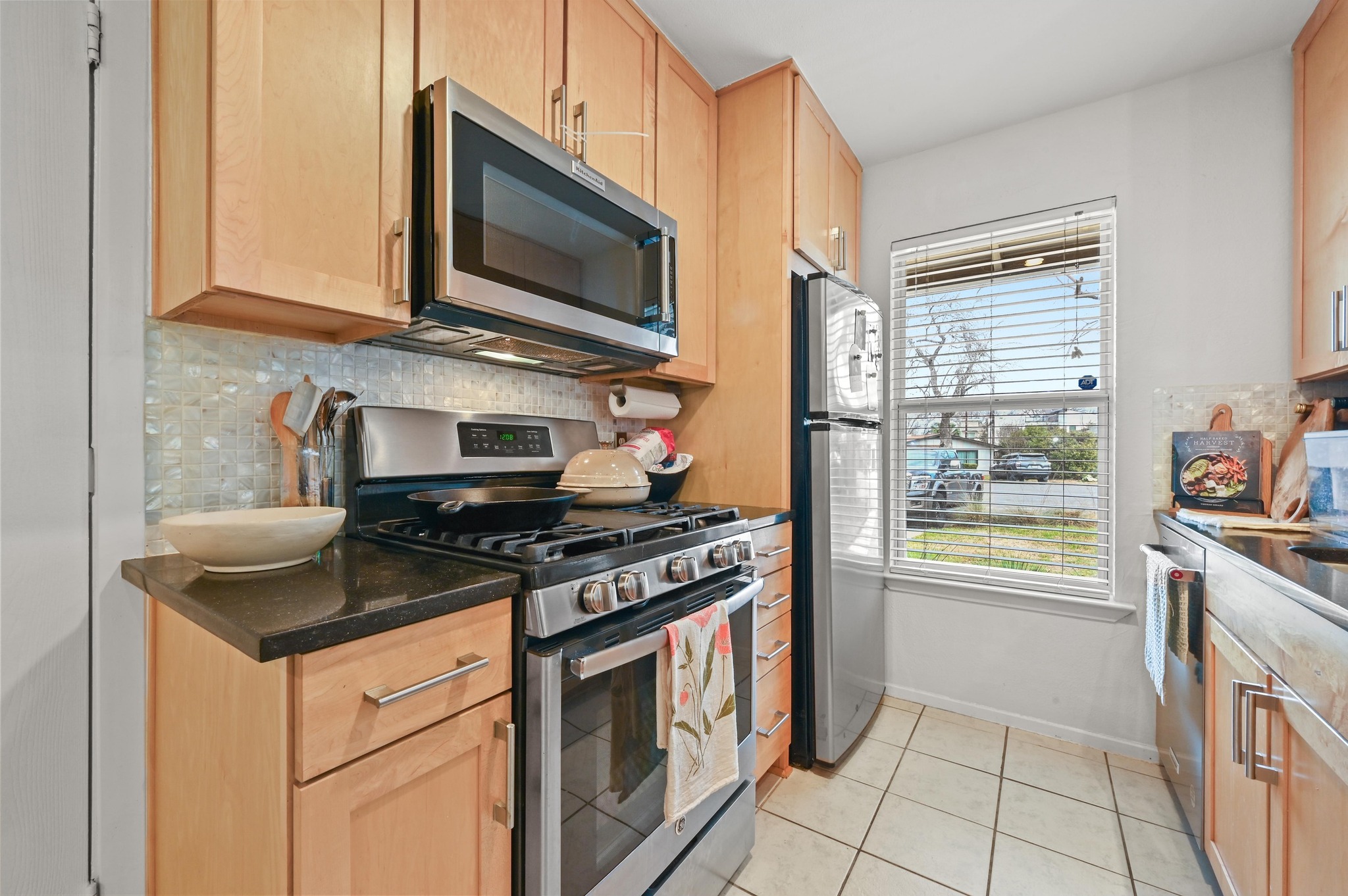 1005 Daphne Court Austin, TX 78704 - Photo 7 of 19 a kitchen with stainless steel appliances granite countertop a stove and a microwave