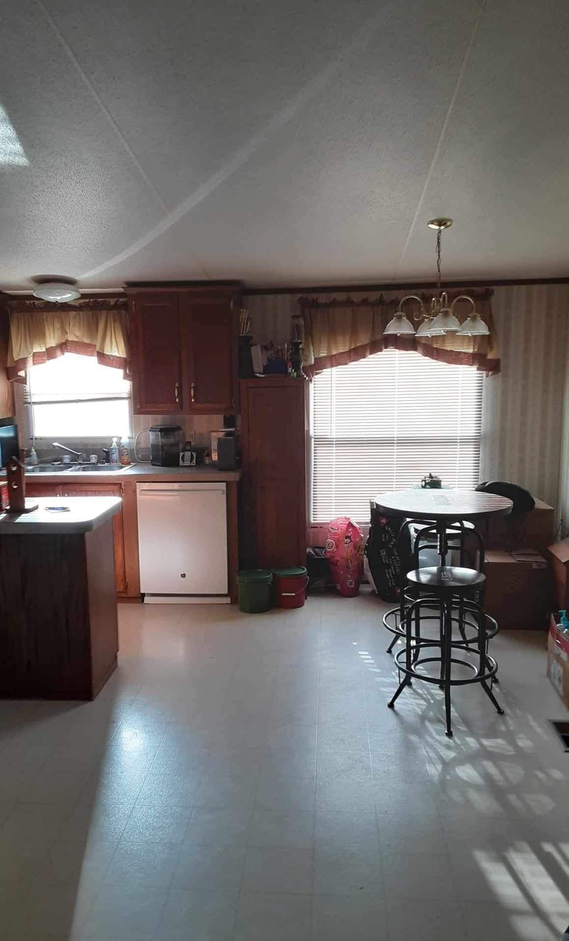 445 Junius Lee Road Ripley, TN 38063 - Photo 6 of 17 a kitchen with a table chairs sink and cabinets