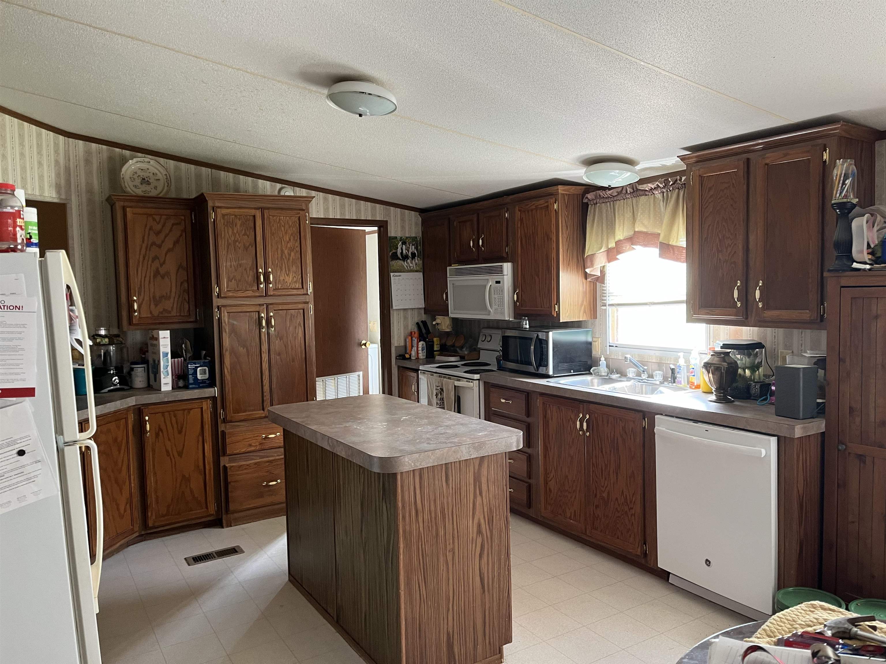 445 Junius Lee Road Ripley, TN 38063 - Photo 9 of 17 a kitchen with granite countertop a refrigerator stove top oven a sink and dishwasher