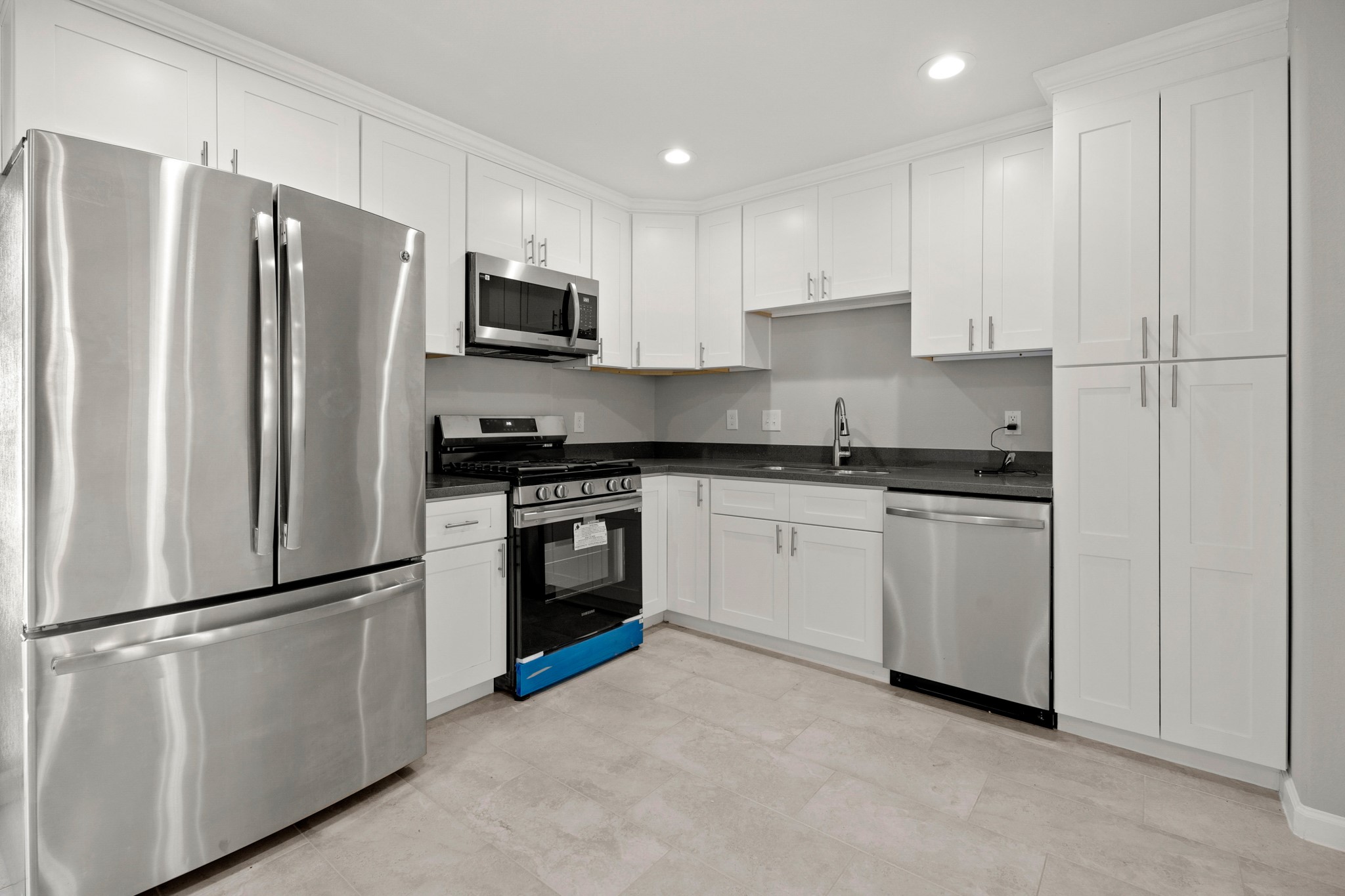 5123 Ridgeway Drive Houston, TX 77033 - Photo 7 of 21 Host your next dinner party with confidence! This kitchen features tile floors, recessed lighting, an abundance of cabinetry, and granite countertops.