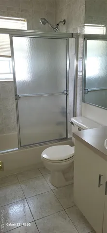 a bathroom with a toilet a sink and a shower