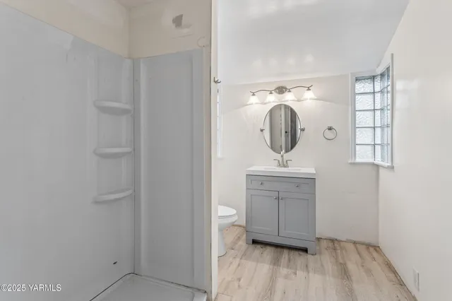 a bathroom with a sink a light fixture and a mirror