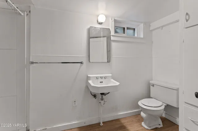 a bathroom with a toilet sink and mirror