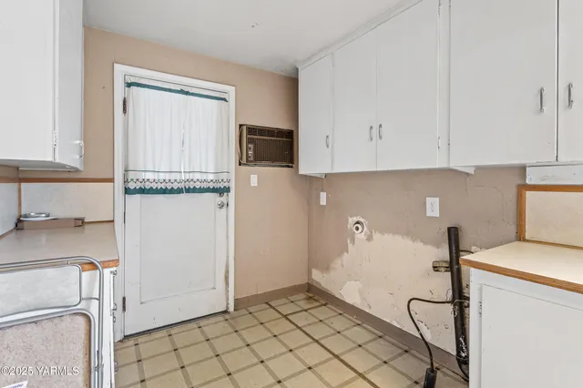 a kitchen with a sink appliances and cabinets