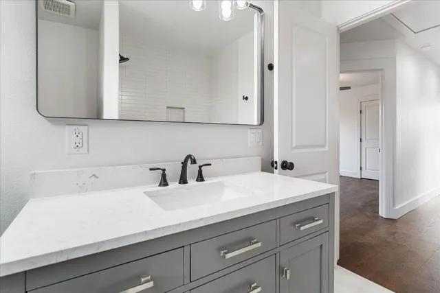 a bathroom with a sink and a mirror