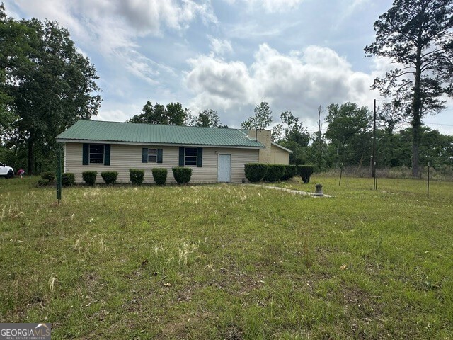 308 Three Rivers Lane Uvalda, GA 30473 - Photo 1 of 28 a front view of a house with garden