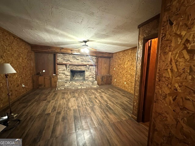 308 Three Rivers Lane Uvalda, GA 30473 - Photo 5 of 28 wooden floor in an empty room with a fireplace