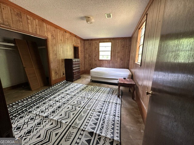 308 Three Rivers Lane Uvalda, GA 30473 - Photo 9 of 28 a bedroom with a bed and a dresser with rug